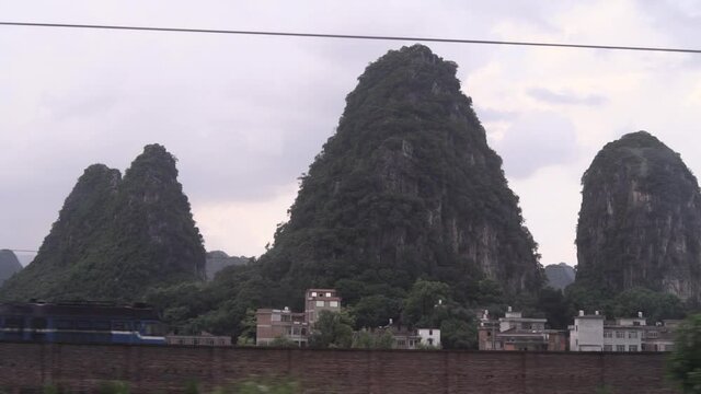 View od Karst Mountains passing by train window in China