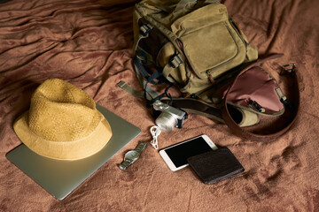 Concept travel prop with a hat and bag and laptop            