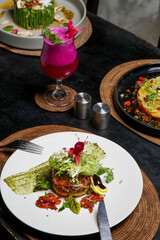 Exquisite dishes. Beautifully decorated healthy organic food served on the table. Modern creative restaurant meals.