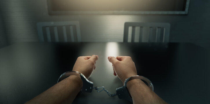 Handcuffed Hands In An Interrogation Room / Composite On A 3D Background