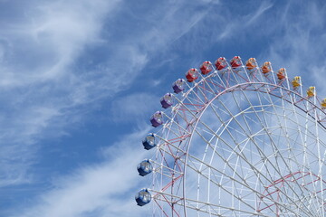 Part of Ferris wheel with the blue sky in the morning.