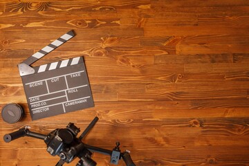 Movie production clapper board over wooden background. Video Equipment. Top view. Copy space.
