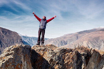 Man with backpack hiking in mountains. Travel Lifestyle success concept adventure active vacations outdoor mountaineering sport