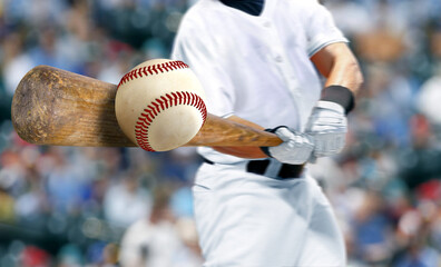 Baseball player hitting ball with bat in close up - obrazy, fototapety, plakaty
