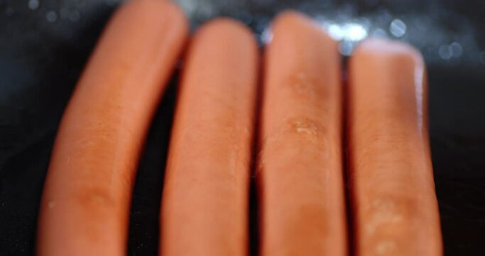 Turn the sausage with a wooden spatula in a hot pan.