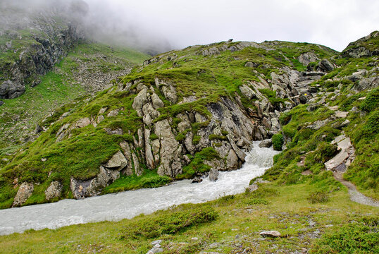 mountain landscape with green grass and clouds