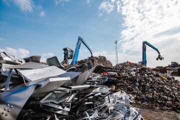 Claw crane grabbing the scrap at a rubbish dump