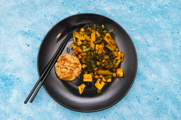 plant-based food, veganvegan tofu kale and stir fry veggies curry with satay rice