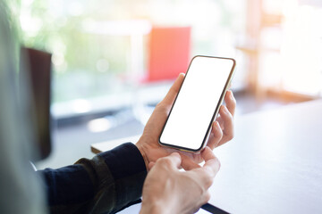 cell phone mockup image blank white screen.woman hand holding texting using mobile on desk at coffee shop.background empty space for advertise.work people contact marketing business,technology