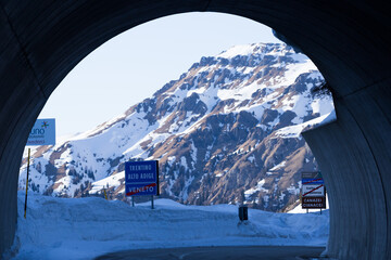 Passo Fedaia, Italy, 02/21/2020 , Gallery on Passo Fedaia, indicating the borderline between...