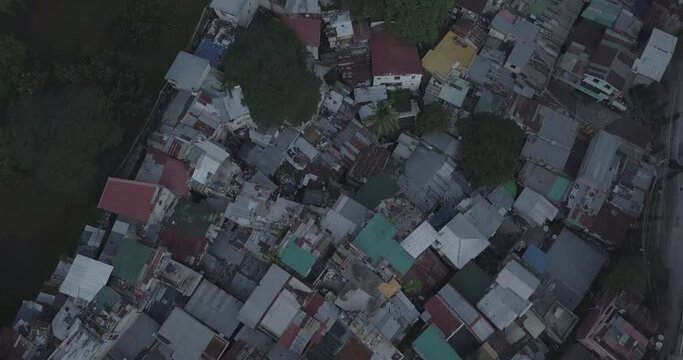 Ungraded, Contrast aerial flight of poor housing area, Tilt up to reveal developed business district. Urban view. Drone, 4K. 