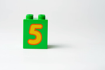 the number five written on the block from the children's constructor