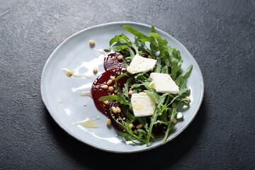 Tasty salad with beetroot and feta. On a black background