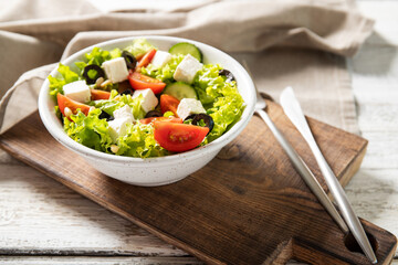 Plate with tasty greek salad on the table. Salad recipe