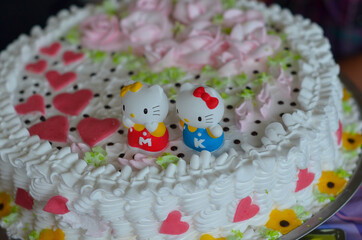 Delicate sponge cake with whipped cream decorated with children's figures