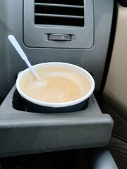 Coffee cup in the cup holder in the car
