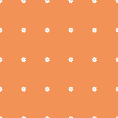 Tiny white flowers on orange background. Seamless tiny vintage flower pattern. Repeating flowers on a orange background. Spring pattern.