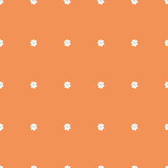 Tiny white flowers on orange background. Seamless tiny vintage flower pattern. Repeating flowers on a orange background. Spring pattern.