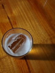 A glass of beer placed on a wooden table
