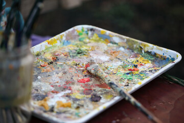 palette with paints and a paintbrush