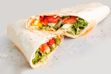 Shawarma sandwich - fresh roll of thin lavash or pita bread filled with grilled meat, mushrooms, cabbage, carrots