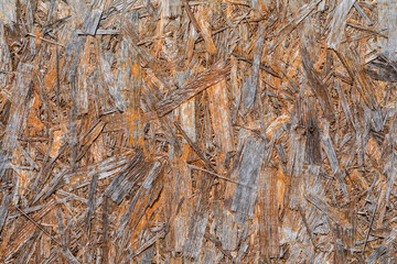 Pattern of an old exterior wall surface made of pressed wood chips and sawdust. Wall of  garden building in the village.