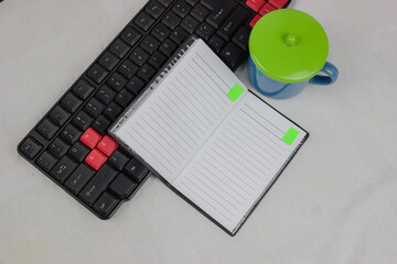 Top view of the workspace with some office supplies isolated white background. Top view with copy space for input the text. The blank paper can be used to put some text or images. office equipment.