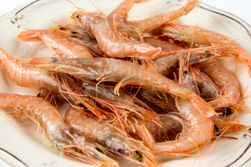 Several raw prawns served on a plate