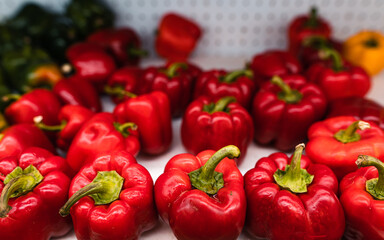 Red and green bell pepper on the shelves
