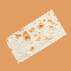 Flat top view of a piece of pita bread, isolated on color background