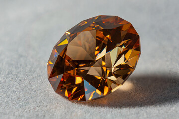 Photo of a Champagne colored Cubic Zirconia gemstone, cut in the shape of a Standard Round...