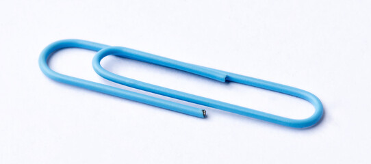 Colored paper clips close-up on a white background