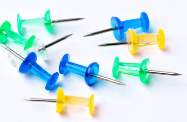 a lot of colorful pushpin close up on white background.