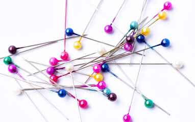 Lot of colorful pins on a white background