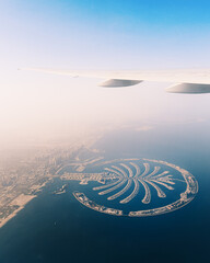 Aerial view of Palm Jumeirah islands in Dubai from the airplane window seat 