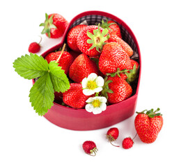 Fresh strawberries in box as heart with green leaf with green leaf. Isolated on white background.