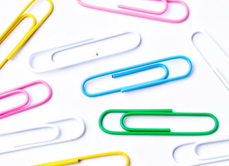 Colored paper clips close-up on a white background