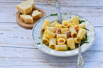 Home made italian carbonara pasta and parmesan cheese on wooden background