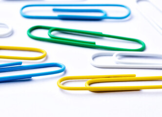 Colored paper clips close-up on a white background