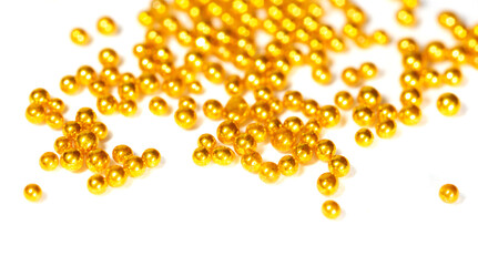 Small balls of gold on a white background.