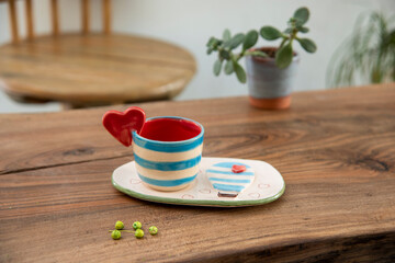 colorful handmade ceramic coffee cup on wooden table