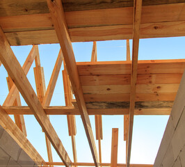 Wooden boards on the roof of the house against the sky.