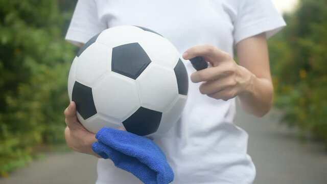 People alcohol spray cleaning soccer football