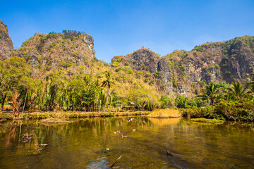 Fototapeta na wymiar Beautiful limestones and water reflections in Rammang Rammang park near Makassar, South Sulawesi, Indonesia