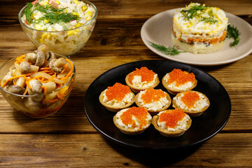 Set of various festive dishes on a wooden table