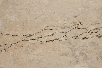 Fototapeta na wymiar Weathered and moldy concrete wall with cracks.