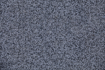 Close view of the wall with mosaic and granulated textured surface. Structural plaster, rough, uneven surface in grey color.