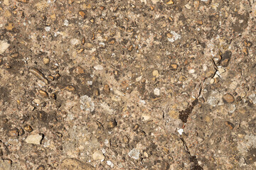 Close up of a lot of different sizes stones that are mixed with cement. The surface of pavement , flooring texture and background for web design and architect.
