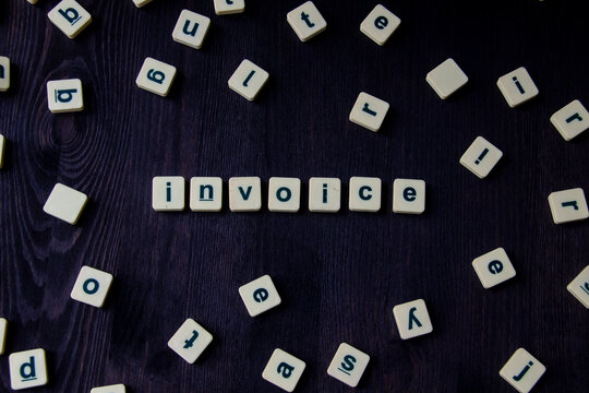 Word or phrase INVOICE made with  letters on the wood, great image for your design.