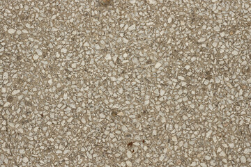 Close up a lot of small or tiny stones that are mixed with cement. The surface of concrete wall,...